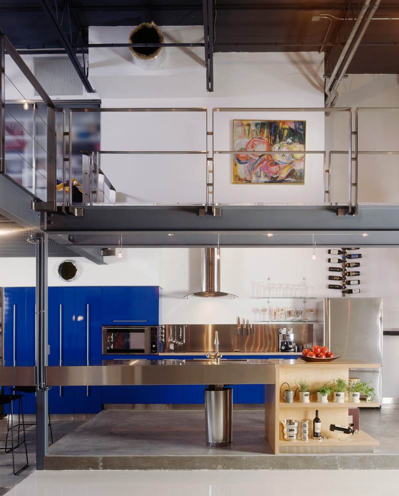 Kitchen - industrial kitchen idea in Tampa with stainless steel appliances and stainless steel countertops