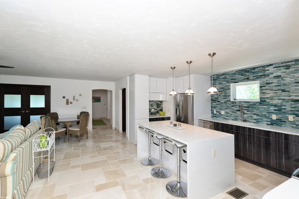 Inspiration for a mid-sized 1960s u-shaped marble floor open concept kitchen remodel in Tampa with a drop-in sink, dark wood cabinets, quartzite countertops, blue backsplash, glass tile backsplash, stainless steel appliances and an island