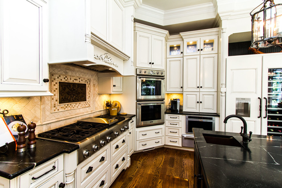 Example of a huge classic galley medium tone wood floor eat-in kitchen design in Richmond with a double-bowl sink, raised-panel cabinets, beige cabinets, onyx countertops, beige backsplash, stone tile backsplash, paneled appliances and two islands