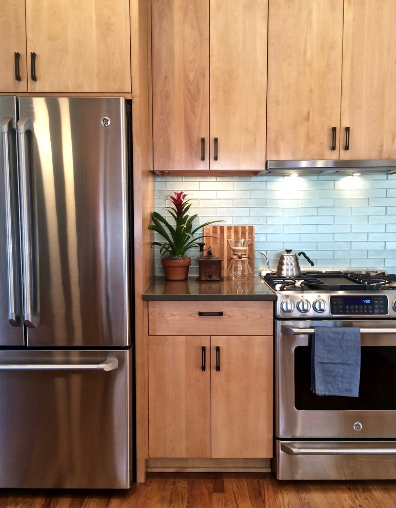 Inspiration for a mid-sized contemporary u-shaped medium tone wood floor eat-in kitchen remodel in San Francisco with an undermount sink, flat-panel cabinets, light wood cabinets, quartz countertops, green backsplash, glass tile backsplash, stainless steel appliances and no island