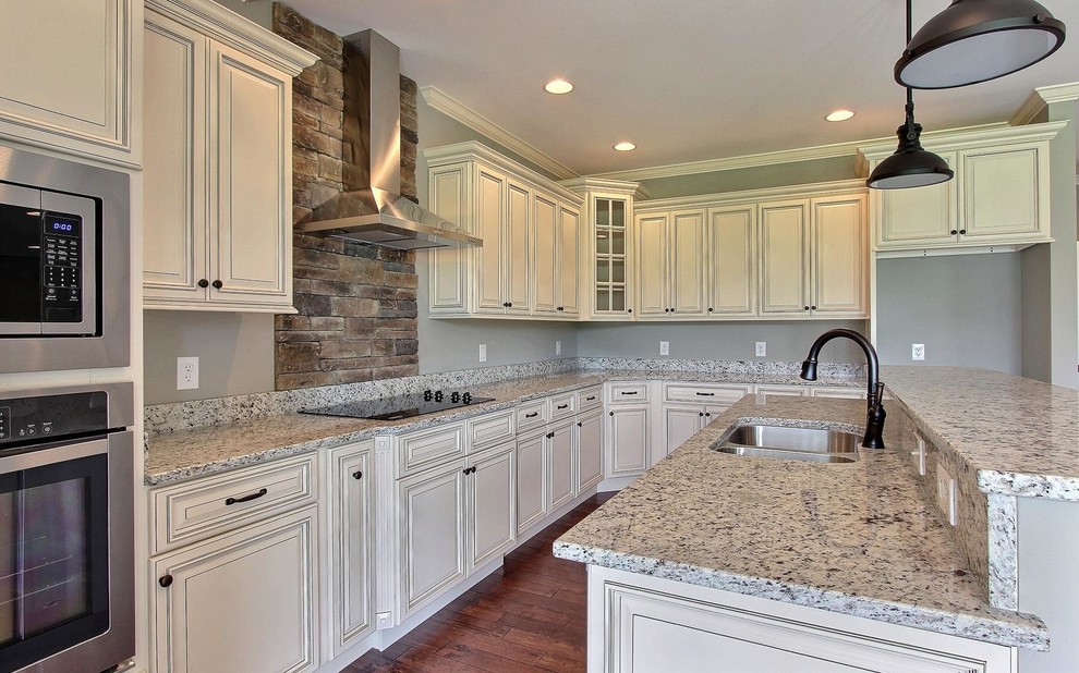 Photo of a medium sized traditional l-shaped enclosed kitchen in Other with a submerged sink, beaded cabinets, white cabinets, engineered stone countertops, stainless steel appliances, dark hardwood flooring, an island and brown floors.
