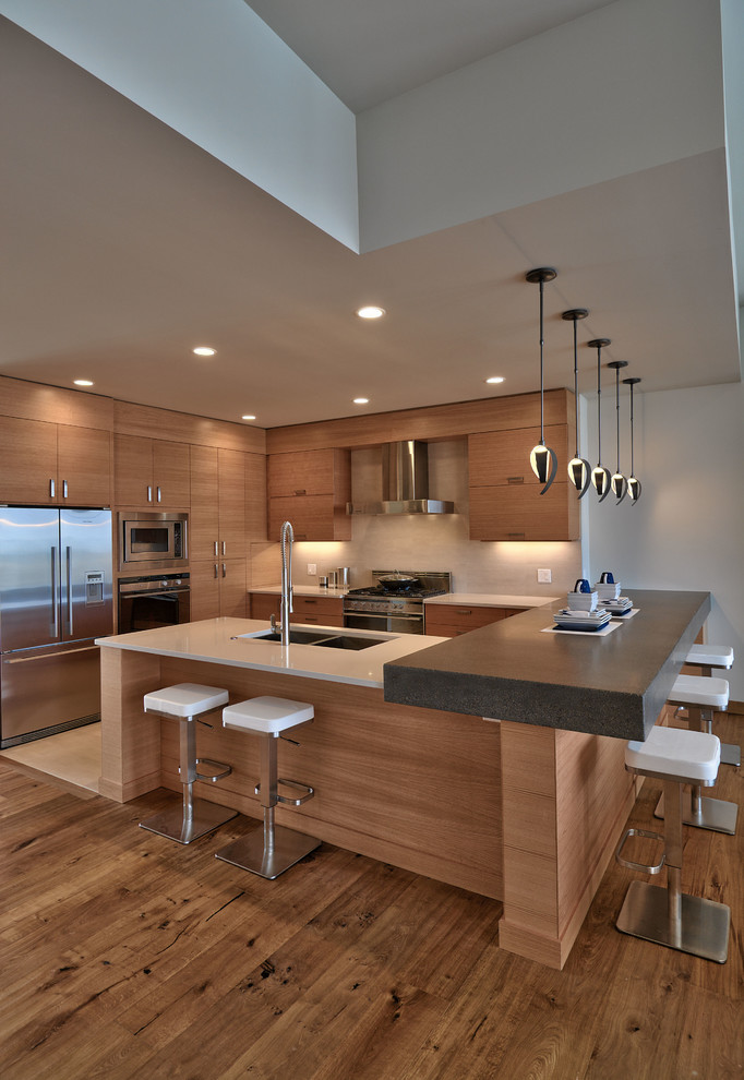 Open concept kitchen - mid-sized contemporary u-shaped medium tone wood floor open concept kitchen idea in Other with a double-bowl sink, flat-panel cabinets, medium tone wood cabinets, beige backsplash and stainless steel appliances