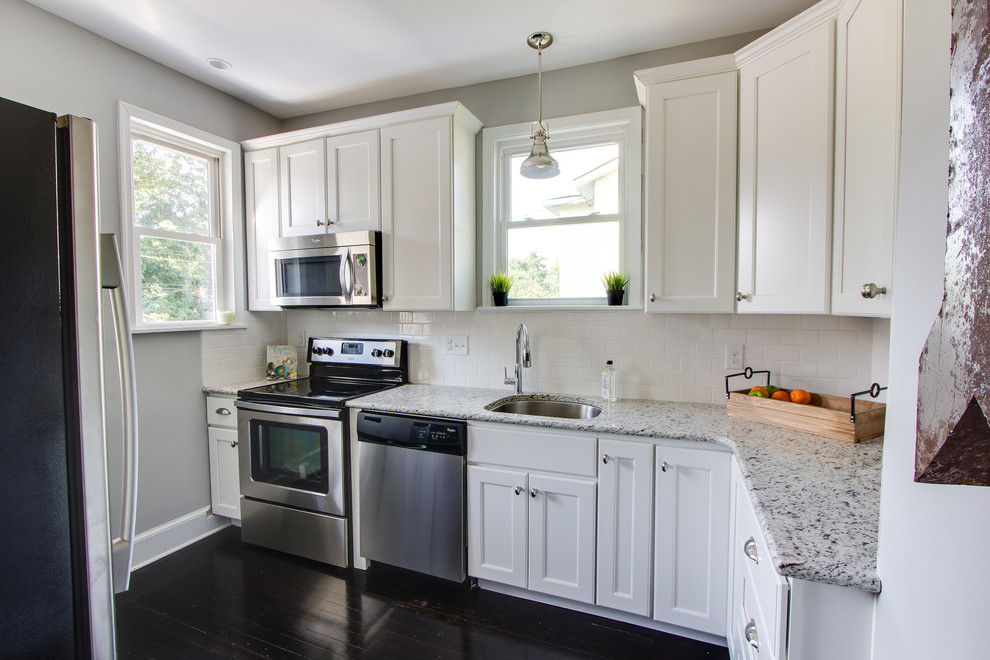 Inspiration for a small timeless galley dark wood floor enclosed kitchen remodel in Richmond with flat-panel cabinets, white cabinets, white backsplash, subway tile backsplash, stainless steel appliances and no island