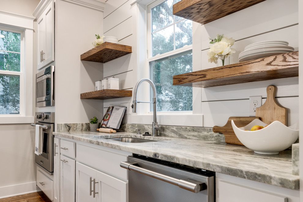 Example of a large arts and crafts galley medium tone wood floor and brown floor eat-in kitchen design in Richmond with an undermount sink, recessed-panel cabinets, white cabinets, granite countertops, white backsplash, shiplap backsplash, stainless steel appliances, an island and gray countertops