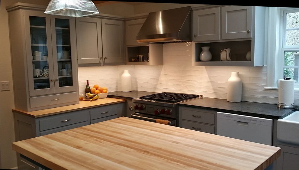 This is an example of an eclectic u-shaped kitchen in Other with shaker cabinets, grey cabinets, soapstone worktops, white splashback, ceramic splashback, lino flooring and an island.