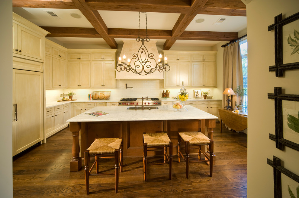 Large mountain style u-shaped dark wood floor eat-in kitchen photo in Houston with recessed-panel cabinets, light wood cabinets, marble countertops, beige backsplash, ceramic backsplash, paneled appliances and an island