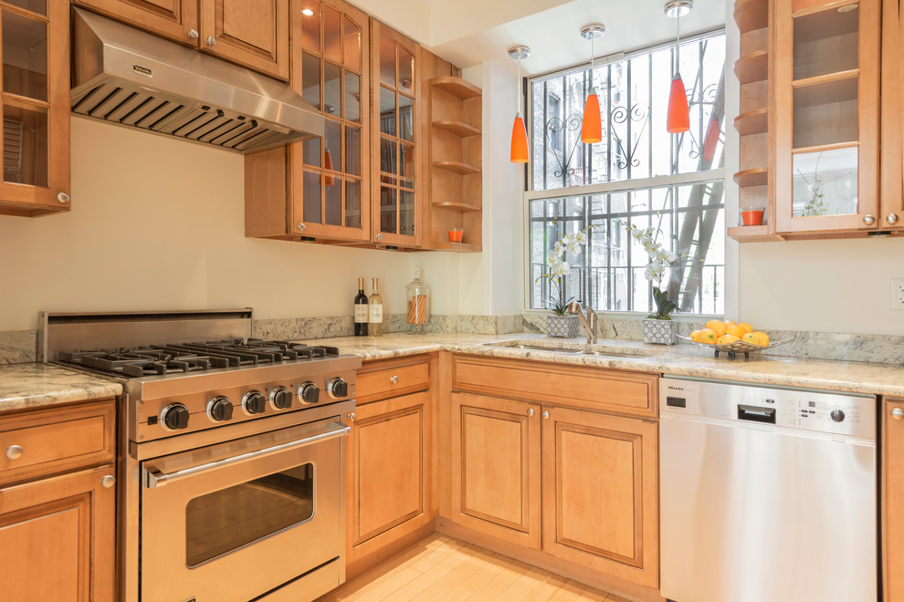 Photo of a medium sized contemporary kitchen pantry in New York with a built-in sink, recessed-panel cabinets, light wood cabinets, marble worktops, stainless steel appliances, light hardwood flooring and no island.
