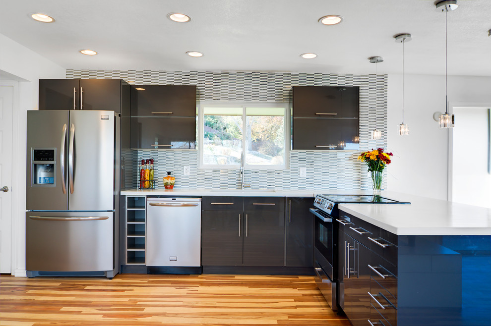 Moderne Küche in L-Form mit Betonarbeitsplatte, Küchengeräten aus Edelstahl, flächenbündigen Schrankfronten, grauen Schränken, Rückwand aus Stäbchenfliesen und bunter Rückwand in Denver