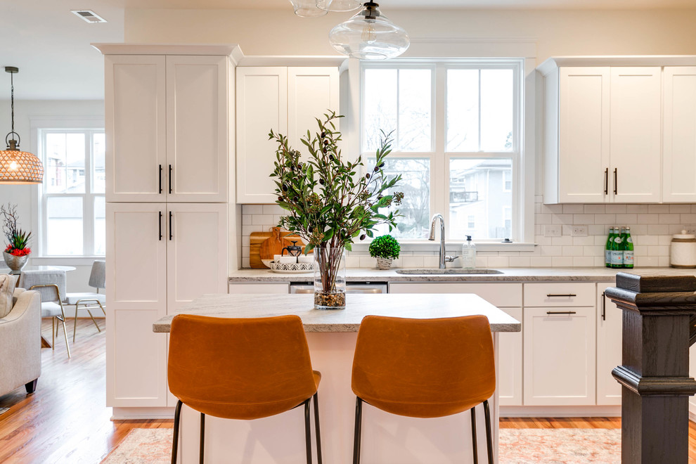 Mid-sized danish l-shaped light wood floor eat-in kitchen photo in Richmond with an undermount sink, recessed-panel cabinets, white cabinets, granite countertops, white backsplash, ceramic backsplash, stainless steel appliances and an island