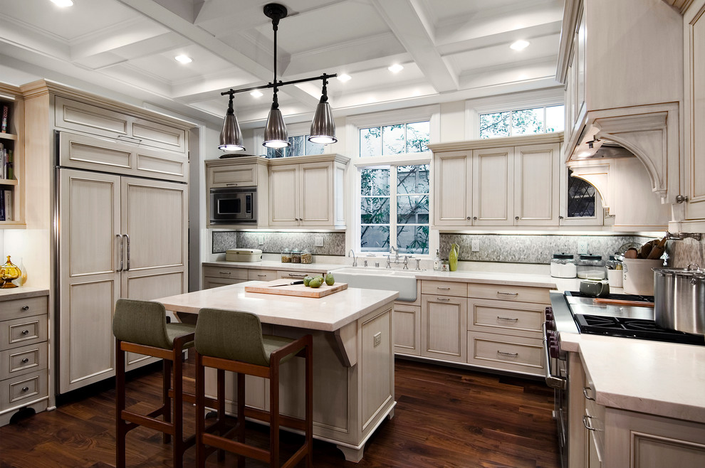 Design ideas for a medium sized classic u-shaped kitchen/diner in Los Angeles with a belfast sink, beaded cabinets, distressed cabinets, stainless steel appliances, dark hardwood flooring and an island.