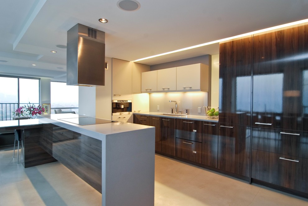 This is an example of a medium sized modern l-shaped kitchen/diner in Chicago with a single-bowl sink, flat-panel cabinets, dark wood cabinets, engineered stone countertops, grey splashback, glass sheet splashback, stainless steel appliances, concrete flooring and an island.