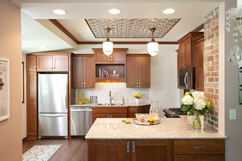 Inspiration for a small timeless u-shaped dark wood floor eat-in kitchen remodel in Minneapolis with quartz countertops, white backsplash, porcelain backsplash, stainless steel appliances, a drop-in sink, shaker cabinets, dark wood cabinets and a peninsula