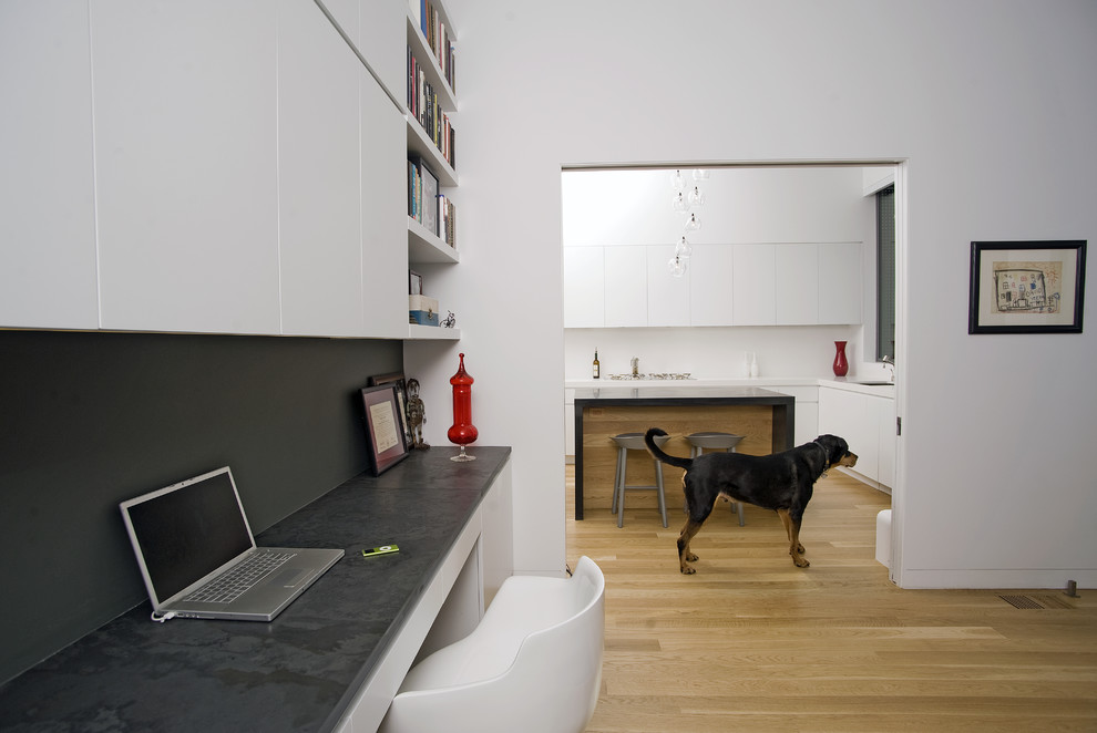 Photo of a contemporary kitchen in San Francisco with flat-panel cabinets and white cabinets.