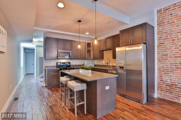 Inspiration for a mid-sized 1950s galley medium tone wood floor and brown floor eat-in kitchen remodel in Baltimore with an undermount sink, shaker cabinets, medium tone wood cabinets, granite countertops, multicolored backsplash, marble backsplash, stainless steel appliances and an island