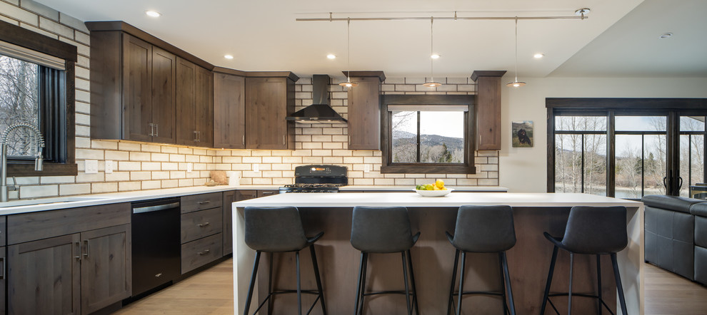 Photo of a medium sized contemporary l-shaped open plan kitchen in Denver with shaker cabinets, medium wood cabinets, metro tiled splashback, an island and white worktops.