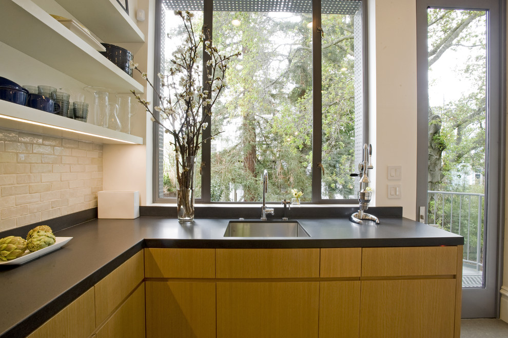 This is an example of a modern kitchen in San Francisco with metro tiled splashback.