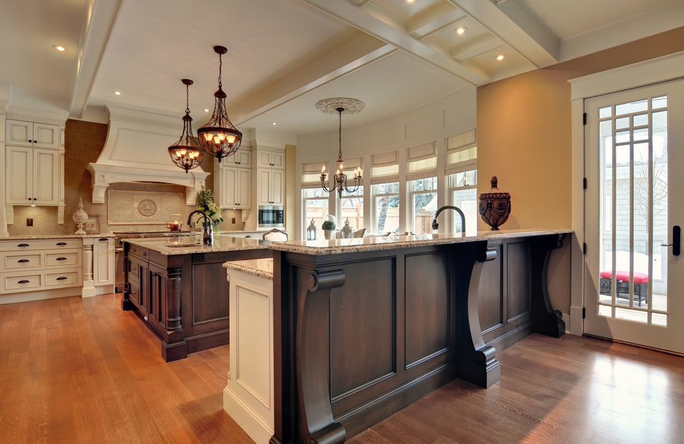 Inspiration for a french country l-shaped dark wood floor enclosed kitchen remodel in Calgary with an undermount sink, recessed-panel cabinets, beige cabinets, granite countertops, beige backsplash, cement tile backsplash, stainless steel appliances and an island