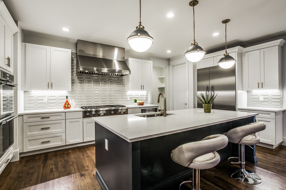 Large contemporary u-shaped open plan kitchen in Dallas with a submerged sink, beaded cabinets, green cabinets, marble worktops, white splashback, ceramic splashback, stainless steel appliances, dark hardwood flooring, an island, brown floors, white worktops and a coffered ceiling.