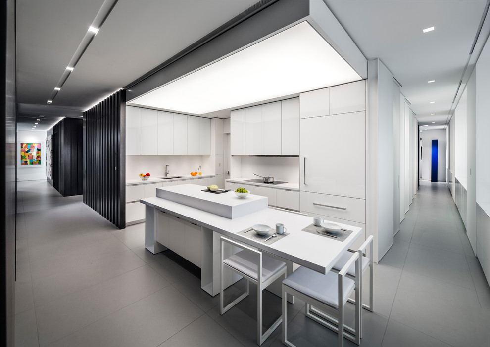 Moderne Küche mit flächenbündigen Schrankfronten, weißen Schränken, Küchenrückwand in Weiß und Kücheninsel in New York