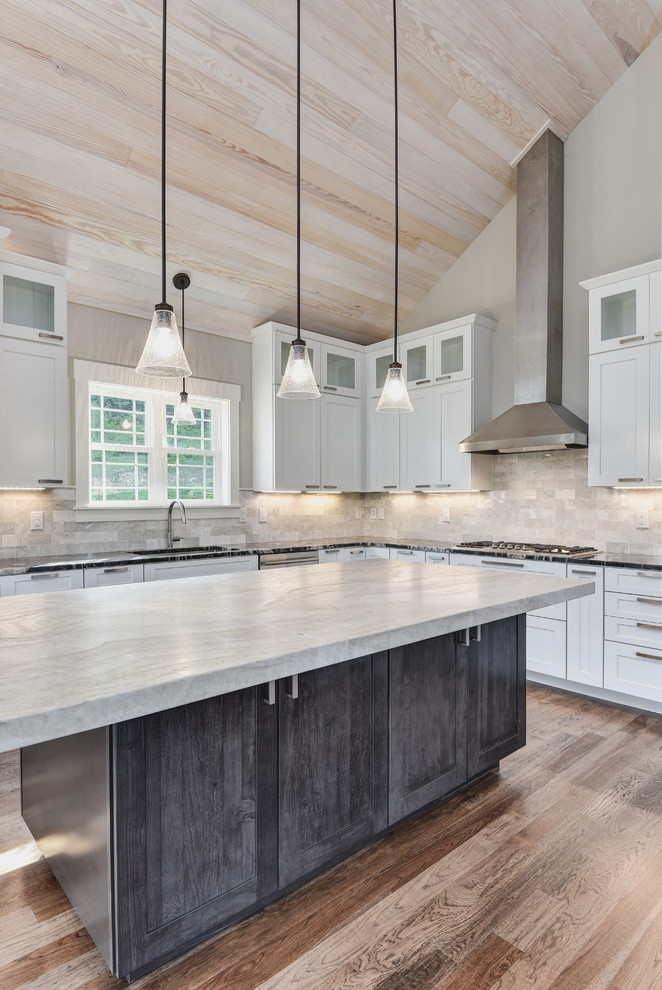 Eat-in kitchen - mid-sized craftsman l-shaped dark wood floor and brown floor eat-in kitchen idea in Other with an undermount sink, shaker cabinets, white cabinets, granite countertops, gray backsplash, stone tile backsplash, stainless steel appliances, an island and multicolored countertops