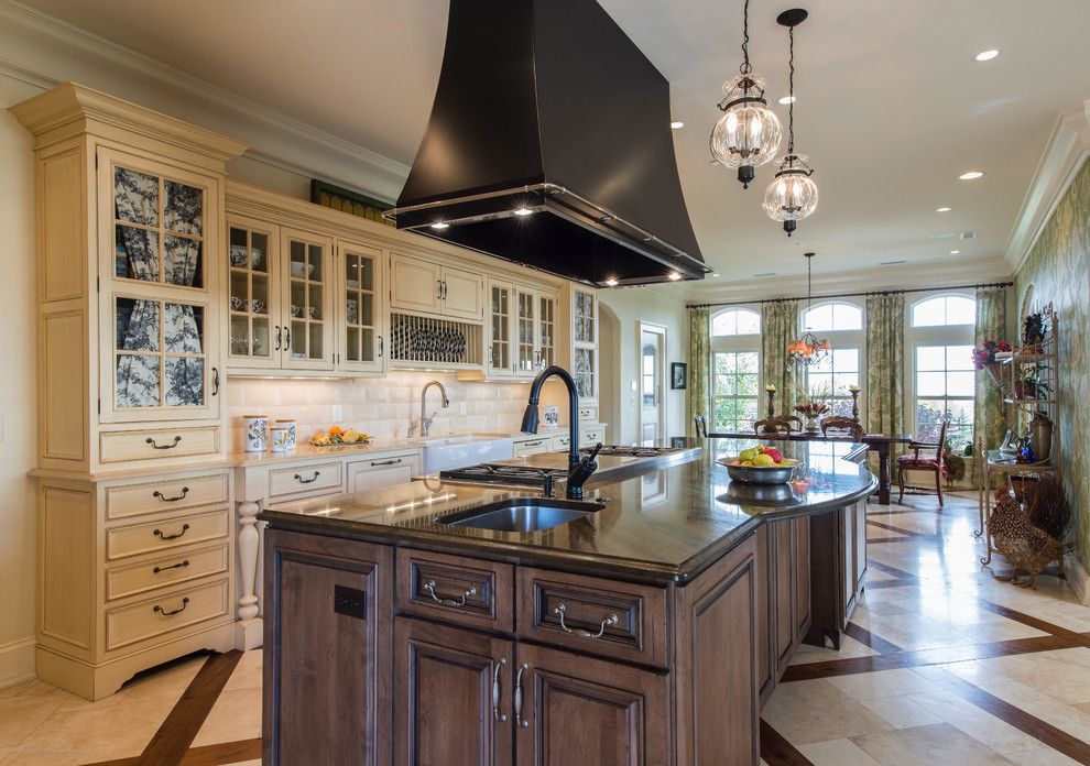 Inspiration for a farmhouse galley multicolored floor eat-in kitchen remodel in Denver with a farmhouse sink, raised-panel cabinets, beige cabinets, white backsplash and an island