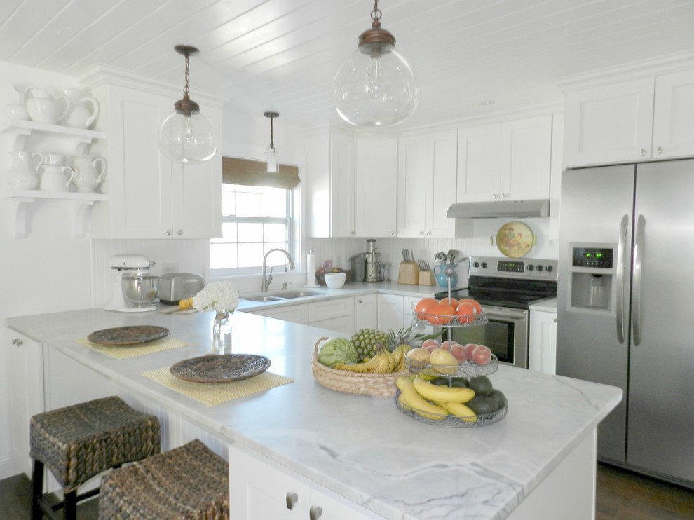Inspiration for a rural open plan kitchen in Orlando with a submerged sink, shaker cabinets, white cabinets, marble worktops, white splashback, wood splashback, stainless steel appliances, dark hardwood flooring and brown floors.