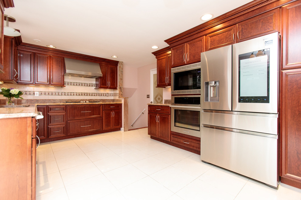 Example of a huge classic u-shaped ceramic tile and white floor open concept kitchen design in Boston with a drop-in sink, recessed-panel cabinets, medium tone wood cabinets, granite countertops, beige backsplash, cement tile backsplash and stainless steel appliances