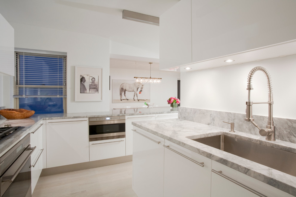 Example of a trendy kitchen design in New York with stainless steel appliances and granite countertops