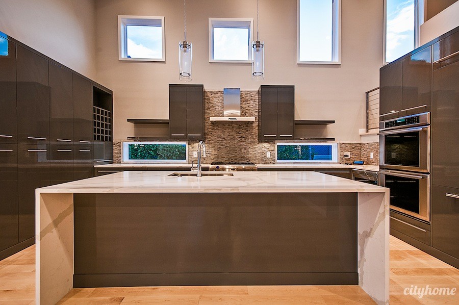 Example of a mid-sized minimalist u-shaped open concept kitchen design in Salt Lake City with flat-panel cabinets, gray cabinets, colored appliances and an island