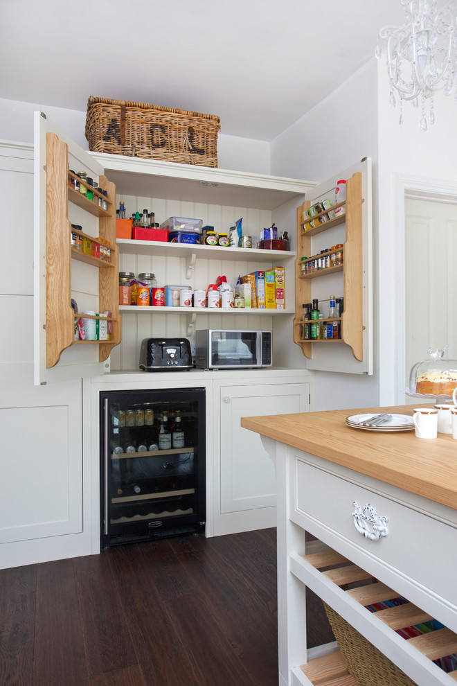 Photo of a country kitchen in Surrey with shaker cabinets and an island.