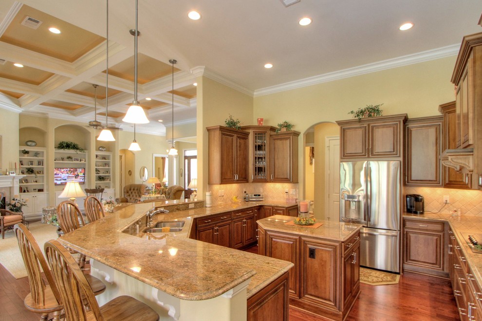 Example of a mid-sized classic u-shaped dark wood floor eat-in kitchen design in Atlanta with an undermount sink, louvered cabinets, dark wood cabinets, granite countertops, beige backsplash, ceramic backsplash, stainless steel appliances and two islands