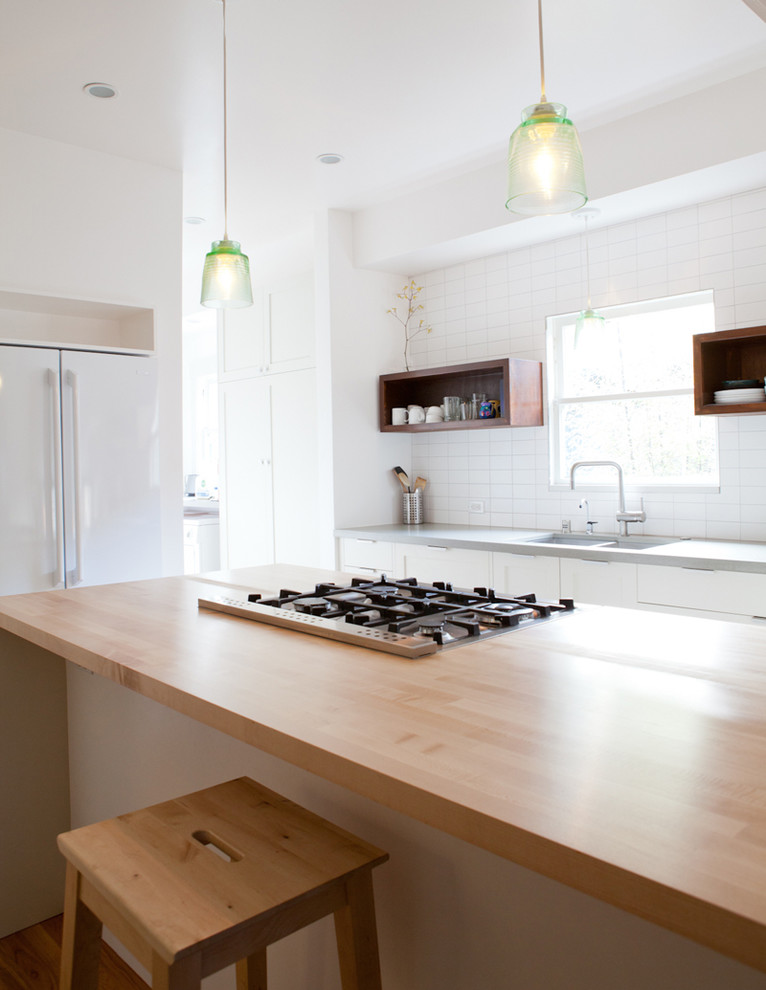 Photo of a contemporary kitchen in San Francisco with white appliances and wood worktops.