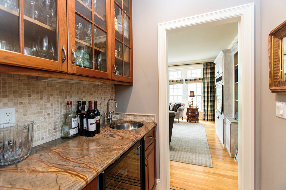 Inspiration for a medium sized classic galley kitchen pantry in Boston with raised-panel cabinets, medium wood cabinets, granite worktops, beige splashback and ceramic splashback.