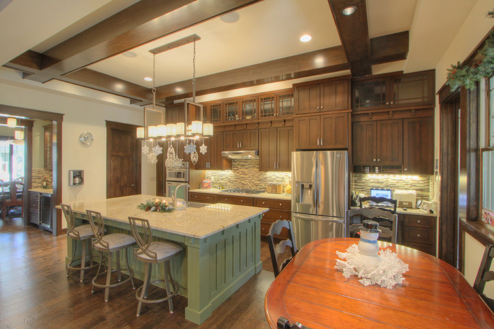 Eat-in kitchen - large craftsman dark wood floor eat-in kitchen idea in Atlanta with a single-bowl sink, glass tile backsplash, stainless steel appliances and an island