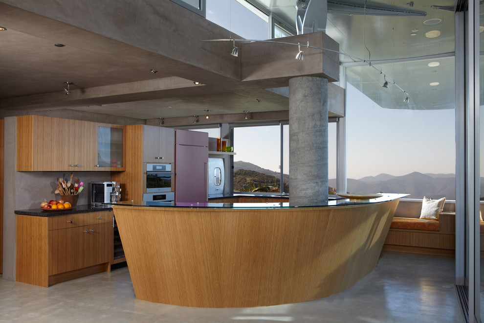 Inspiration for a modern kitchen remodel in Los Angeles with flat-panel cabinets, medium tone wood cabinets and stainless steel appliances