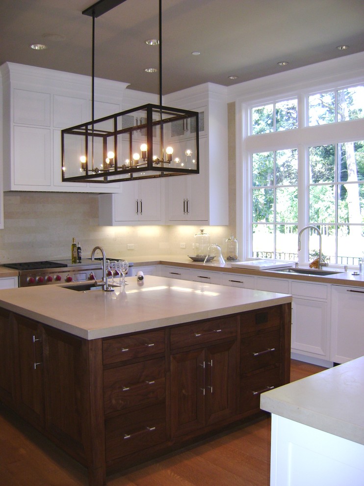 Photo of a large traditional u-shaped kitchen/diner in San Francisco with recessed-panel cabinets, brown cabinets, marble worktops and an island.