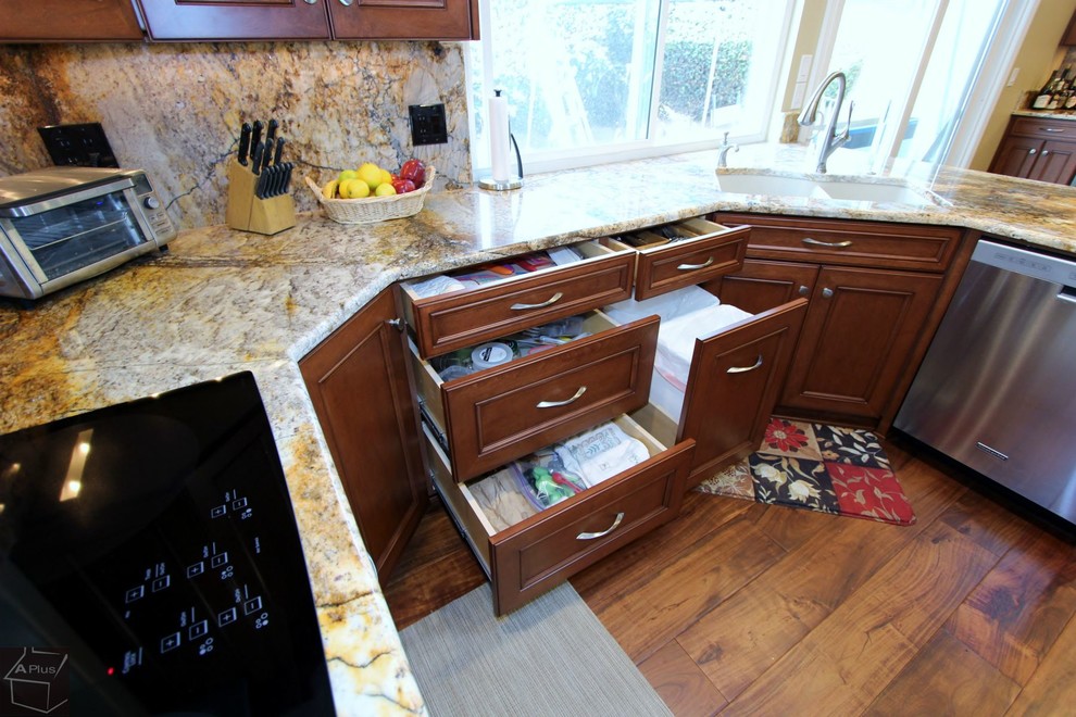 Eat-in kitchen - large contemporary u-shaped medium tone wood floor eat-in kitchen idea in Orange County with a double-bowl sink, recessed-panel cabinets, medium tone wood cabinets, granite countertops, multicolored backsplash, stone slab backsplash, stainless steel appliances and a peninsula