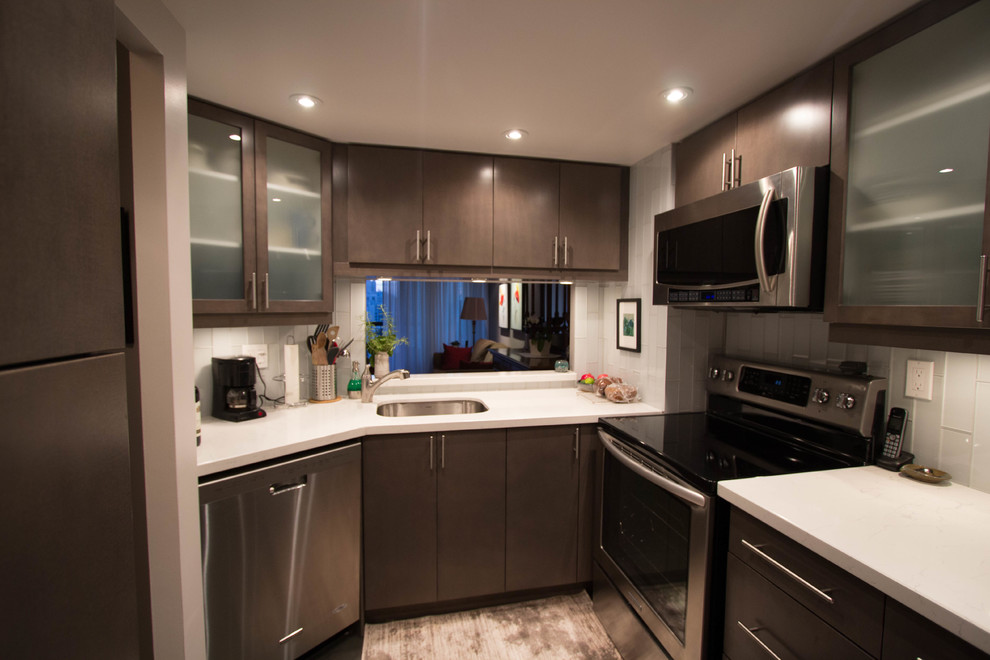 Small minimalist l-shaped ceramic tile enclosed kitchen photo in Toronto with a single-bowl sink, flat-panel cabinets, brown cabinets, quartzite countertops, white backsplash, glass tile backsplash, stainless steel appliances and no island