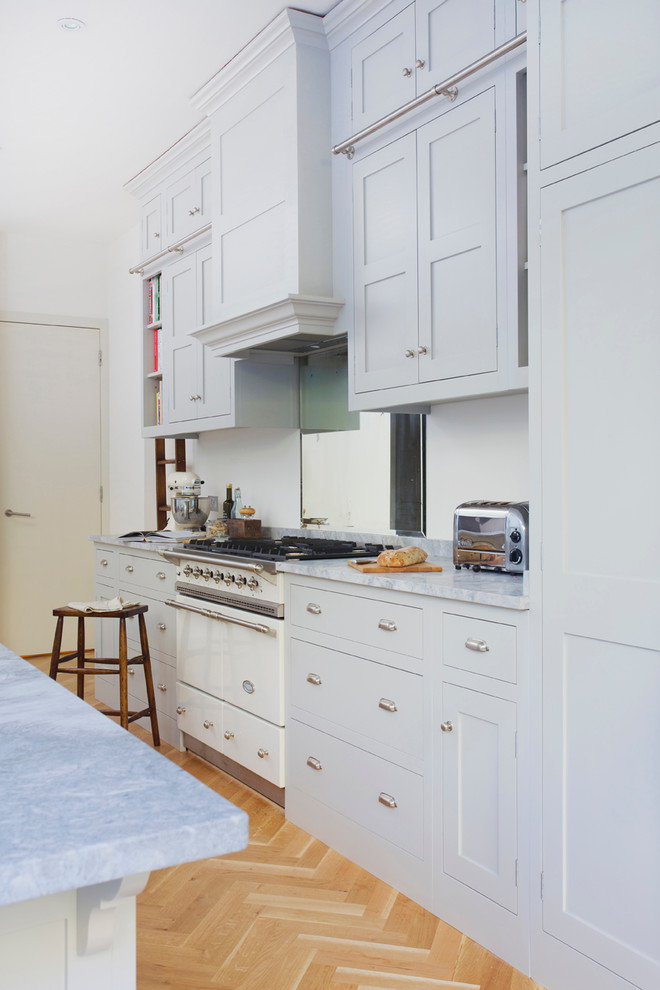 Kitchen - traditional kitchen idea in Surrey with shaker cabinets and an island