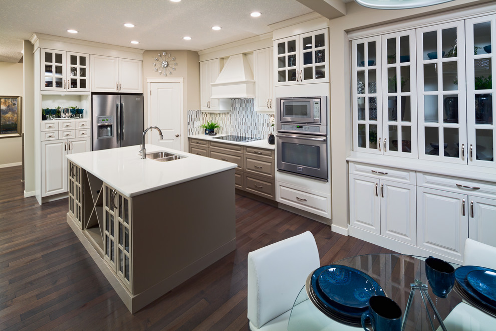 Example of a classic kitchen design in Calgary with matchstick tile backsplash, stainless steel appliances, gray backsplash and a double-bowl sink