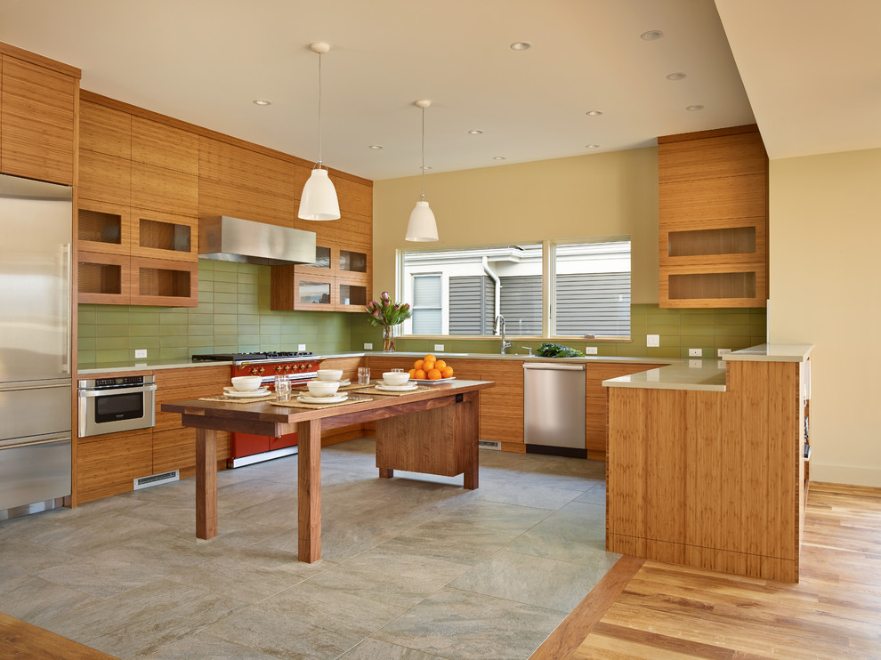 Eat-in kitchen - contemporary u-shaped porcelain tile eat-in kitchen idea in Seattle with an undermount sink, medium tone wood cabinets, quartz countertops, green backsplash, ceramic backsplash, stainless steel appliances and an island