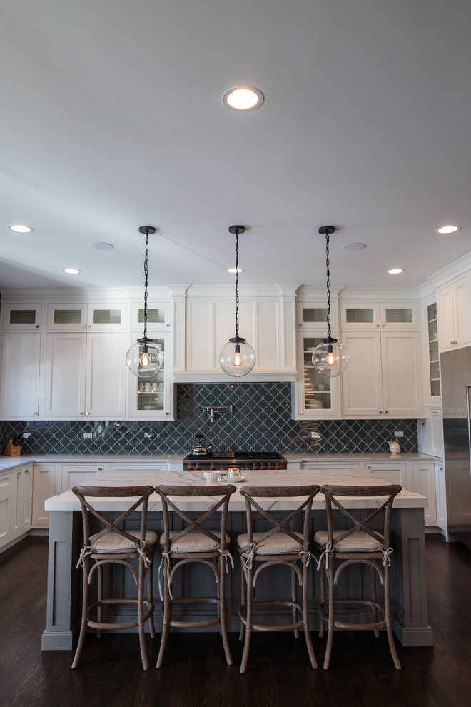 Large transitional u-shaped dark wood floor eat-in kitchen photo in Chicago with an undermount sink, shaker cabinets, white cabinets, marble countertops, glass tile backsplash, stainless steel appliances, an island and gray backsplash