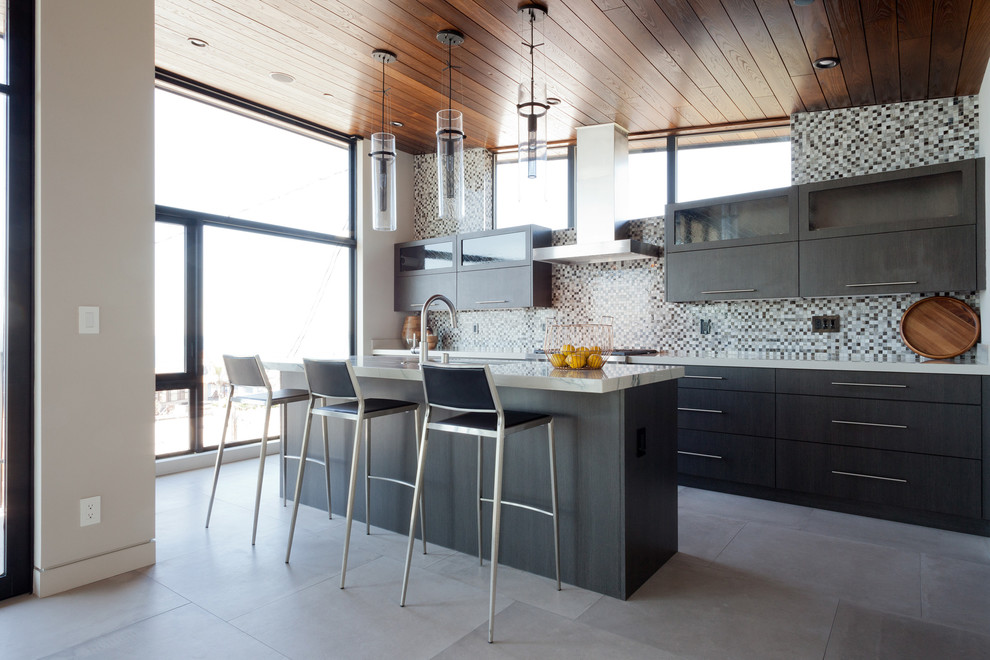 Design ideas for a medium sized contemporary l-shaped open plan kitchen in Los Angeles with a single-bowl sink, flat-panel cabinets, grey cabinets, marble worktops, multi-coloured splashback, mosaic tiled splashback, stainless steel appliances, concrete flooring and an island.