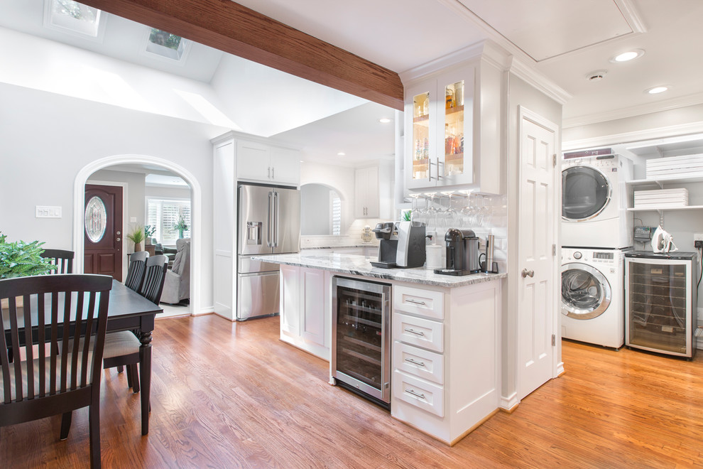 Small transitional u-shaped medium tone wood floor and brown floor eat-in kitchen photo in Other with an undermount sink, shaker cabinets, white cabinets, granite countertops, white backsplash, subway tile backsplash, stainless steel appliances, a peninsula and white countertops