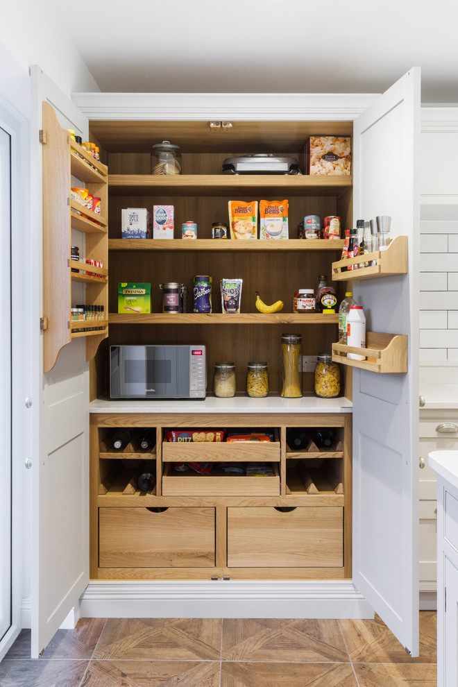 Design ideas for a medium sized classic kitchen pantry in Essex with white worktops and light hardwood flooring.
