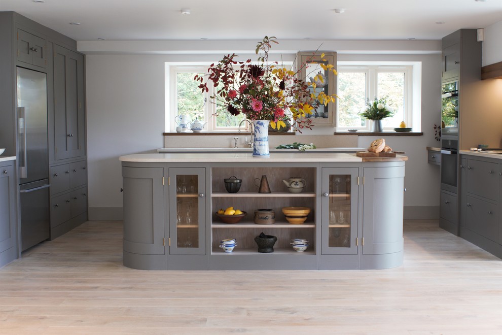 Photo of a medium sized contemporary u-shaped open plan kitchen in Other with shaker cabinets, grey cabinets, marble worktops, beige splashback, stainless steel appliances, an island and marble splashback.