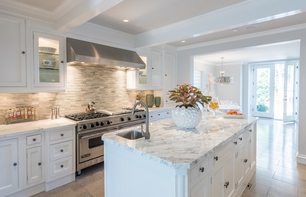 Large trendy u-shaped ceramic tile eat-in kitchen photo in Dallas with a farmhouse sink, recessed-panel cabinets, white cabinets, wood countertops, gray backsplash, stone tile backsplash, paneled appliances and an island