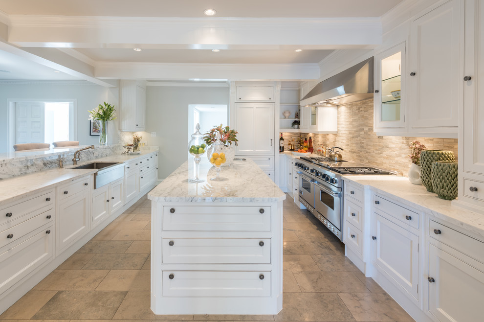 Photo of a large contemporary u-shaped kitchen/diner in Dallas with a belfast sink, recessed-panel cabinets, white cabinets, wood worktops, grey splashback, stone tiled splashback, integrated appliances, ceramic flooring and an island.