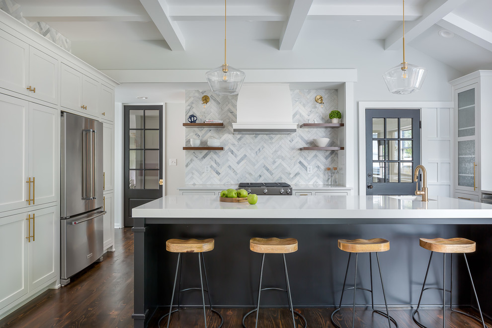 Transitional dark wood floor and brown floor kitchen photo in New York with an undermount sink, shaker cabinets, white cabinets, multicolored backsplash, marble backsplash, stainless steel appliances, an island and white countertops