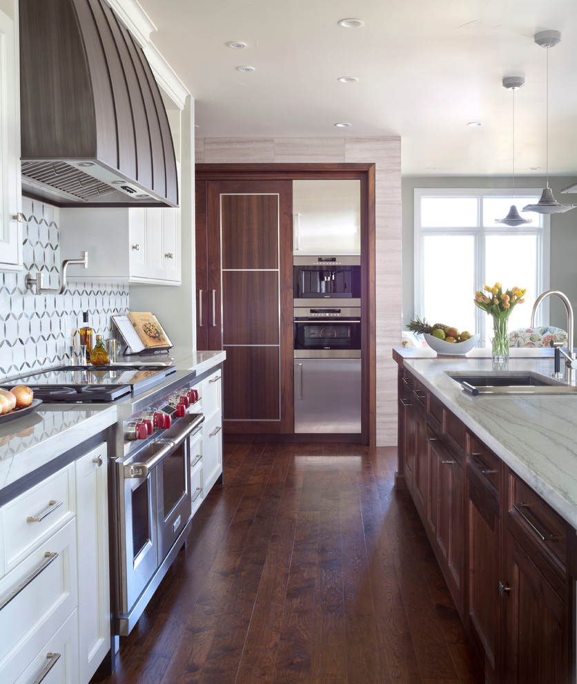 This is an example of a traditional kitchen in Denver with a submerged sink, shaker cabinets, white cabinets, multi-coloured splashback, stainless steel appliances, dark hardwood flooring and an island.